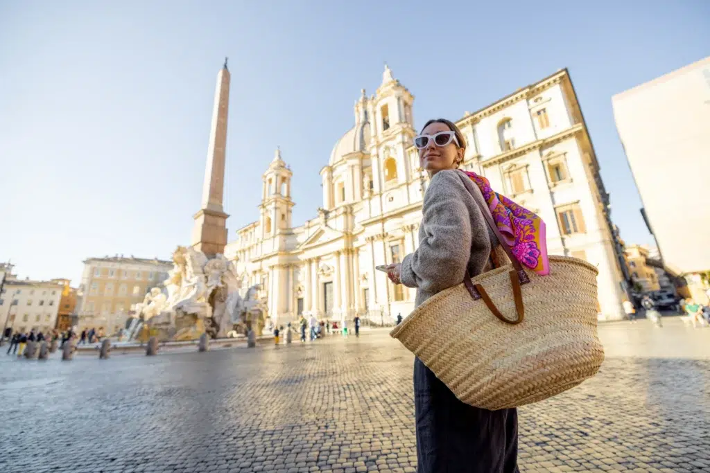 Donna cammina per piazza del popolo a Roma